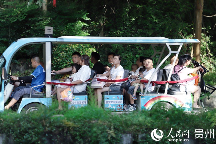 市民在阿哈湖公園內乘坐交通車。人民網(wǎng) 顧蘭云攝