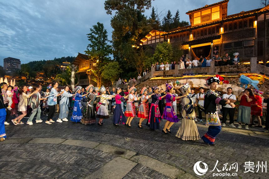 6月24日，在烏江寨景區(qū)，傳統(tǒng)民俗表演吸引眾多游客參與互動。人民網(wǎng)記者 翁奇羽攝